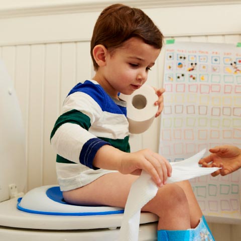 Mom teaching toddler boy how to potty train with Pull-Ups®